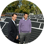 Guys in front of solar panels