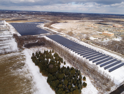 Aerial view of solar arrays in winter.