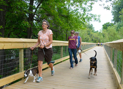 Walkers enjoy the new boardwalk at Phalen-Keller Regional Park in Saint Paul.