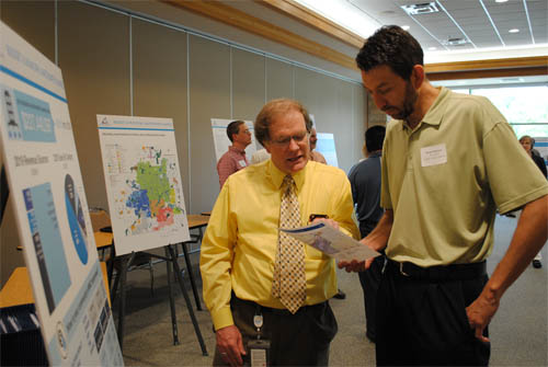 Kyle Colvin, MCES Manager of Engineering Programs, discusses the municipal wastewater charge with Ryan Peterson, Public Works Director for Burnsville at an MCES customer open house.