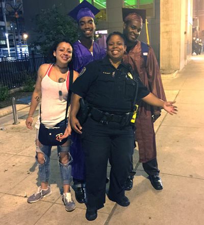 Officer Brooke Blakey on the street with youth she’s worked with in the diversion program.