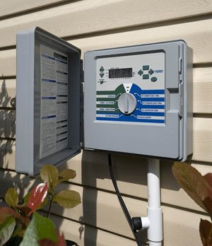 Smart lawn irrigation controller attached to a house.
