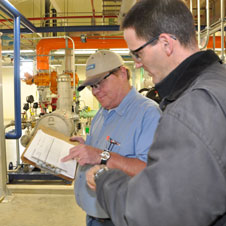photo of two men at an Environmental Services facility