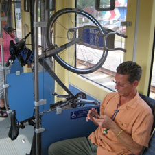 photo of a rider next to a bike on the METRO Blue Line