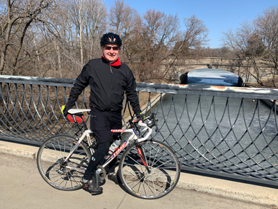 Chair Zelle posing on a bridge with his bike.