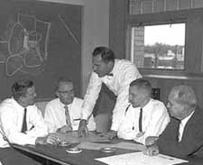 1967 planners at desk.