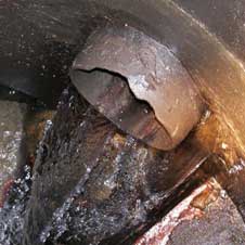photo of a pipe with water pouring out