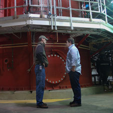 photo of two men standing in a wastewater treatment facility