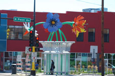 A bus shelter with large flower art.