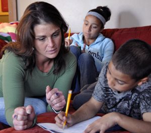 Mom helping kids with homework.