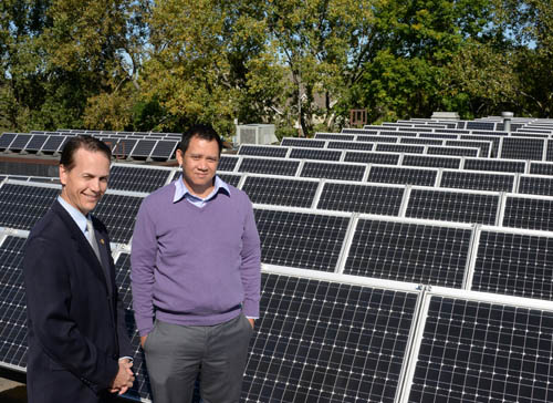 Falcon Heights Mayor Peter Lindstrom (left) and City Administrator Sack Thongvanh check out the city’s solar array on the roof of City Hall. The officials are in the vanguard of a movement to bring more solar power to the public sector.