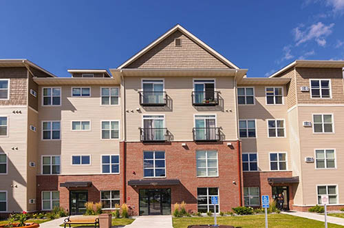 The front of a four-story housing building.