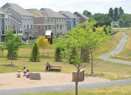 A family plays at Cedarhurst Meadows Park in Cottage Grove’s new East Ridgewoods development.