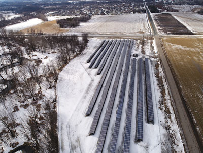 Aerial view of a solar array in winter.