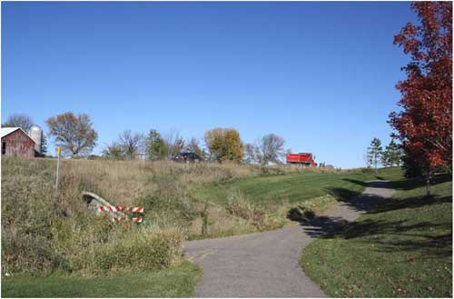 Site of Carver Crossings, a planned multi-family housing development project in a neighborhood near a park-and-ride facility.