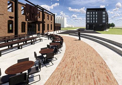 A courtyard with seating next to a brick building.