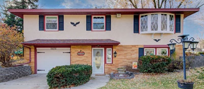 A single-family home with a tuck-under garage.