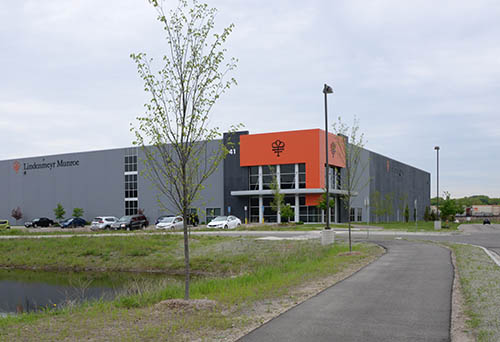 A gray building with an orange entrance.