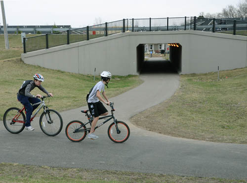 Local kids cruise past the bicycle trail tunnel under Highway 3 near the heart of the Rosemount business district. The tunnel has made bicycle travel much safer in the area near Rosemount High School.