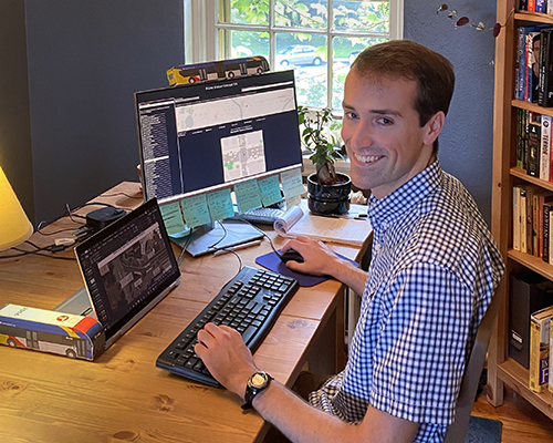 An intern at a computer in a home office.