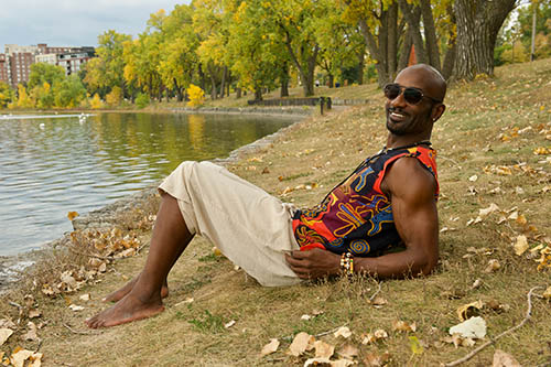 A person relaxing on the shore of a lake.