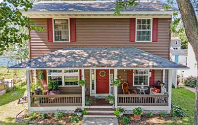 Two-story older home with open front porch.