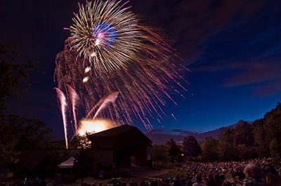 A crowd of people watching fireworks.