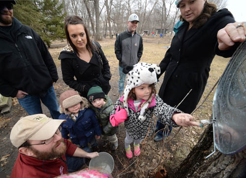 Reaching for a bit of sweetness: learning about maple-syrup making is one of dozens of programs offered at the Wargo Nature Center in the Rice Creek Chain of Lakes Park Reserve.