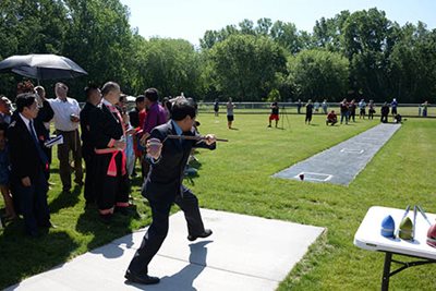 People playing a game in a grassy area of the park.