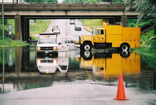 Perhaps the most common form of climate change currently seen in the Twin Cities is excessive rain that floods low-lying areas and can consume city streets, as seen here on Roselawn Avenue under I-35E in Maplewood. (Photo by MnDOT)
