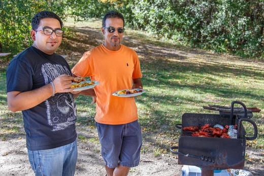 Men picnicking at a park.