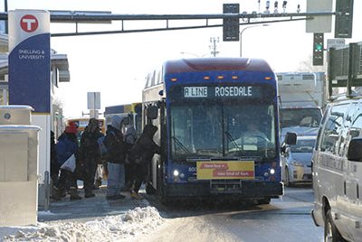 People boarding an A Line bus in winter.