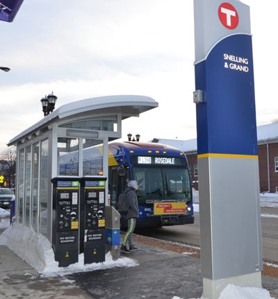 A bus rider walking up to an approaching A Line bus at the Snelling and Grand stop.