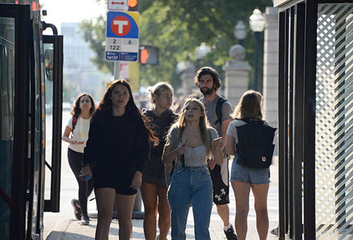 Students walk near a Metro Transit bus stop on the University of Minnesota campus.