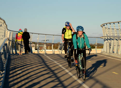 Cyclists cross Highway 55 on the Martin Olav Sabo bridge.