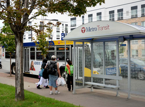 Passengers boarding bus. Fares for regular-route bus and rail service would go up either 25 or 50 cents under a proposal being considered by the Council. State law requires the Council to set fares for all regional transit services