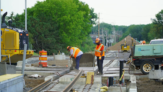 Two construction workers on the new SWLRT line.