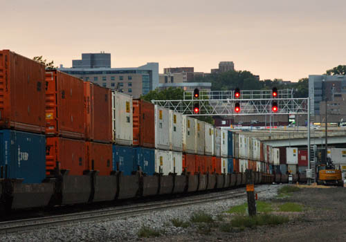 A train loaded with two levels of boxcars.