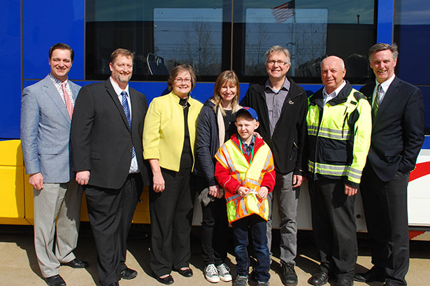 From left to right: Metropolitan Council Chair Adam Duininck; Jason Gadd, Hopkins City Council; Hopkins Mayor Molly Cummings; mom, Jane Meyer; Karlis Barobs; dad, John Barobs; rail operator trainer Dan Syverson; Brian Lamb, General Manager, MetroTransit. From left to right: Metropolitan Council Chair Adam Duininck; Jason Gadd, Hopkins City Council; Hopkins Mayor Molly Cummings; mom, Jane Meyer; Karlis Barobs; dad, John Barobs; rail operator trainer Dan Syverson; Brian Lamb, General Manager, MetroTransit.
