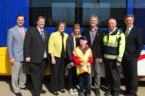 From left to right: Metropolitan Council Chair Adam Duininck; Jason Gadd, Hopkins City Council; Hopkins Mayor Molly Cummings; mom, Jane Meyer; Karlis Barobs; dad, John Barobs; rail operator trainer Dan Syverson; Brian Lamb, General Manager, MetroTransit.