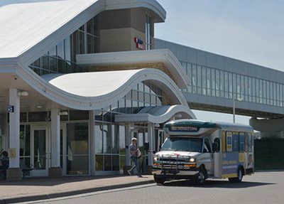 A bus in front of a transit station.