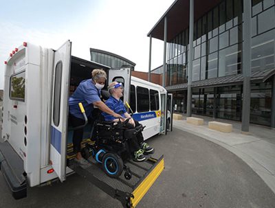 Metro Mobility driver assists a passenger to visit a library.