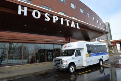 Metro Mobility vehicle parked at a hospital entrance.