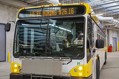 A Metro Transit bus in the North Garage with a driver applicant behind the wheel and a trainer at his side.