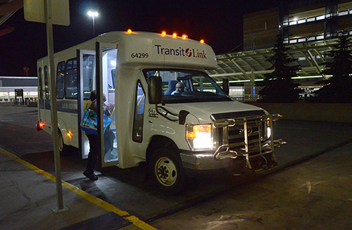 Transit Link bus at the airport at night.