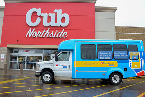 A microtransit bus in front of a Cub Foods.