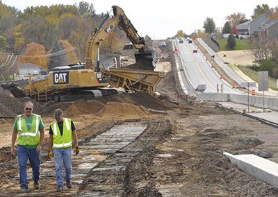 Two workers on a road construction site.