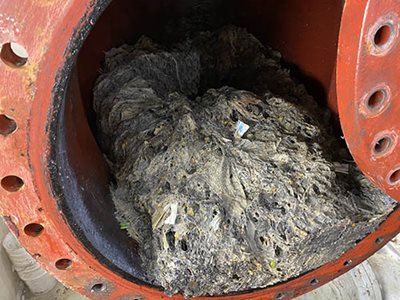 This mass of dried paper products that should not be flushed -- congealed by fats, grease, oil – was recently extracted from a suburban wastewater pumping station by Met Council employees.