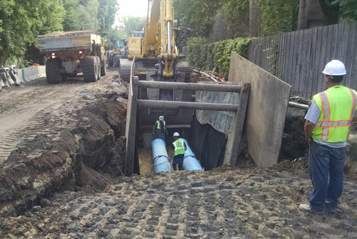 Workers install a new dual force main along Highway 101 in Hennepin County.