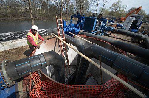 A worker on a construction site near a river.